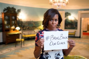 First Lady Michelle Obama holding a sign with the hashtag "#bringbackourgirls" in support of the 2014 Chibok kidnapping. Posted to the FLOTUS Twitter account on May 7, 2014. This image is in the public domain in the United States because it is a work prepared by an officer or employee of the United States Government as part of that person’s official duties under the terms of Title 17, Chapter 1, Section 105 of the US Code. Image contributed by Masem.